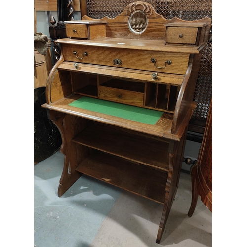 924 - An arts and crafts cylinder bureau with shelves below