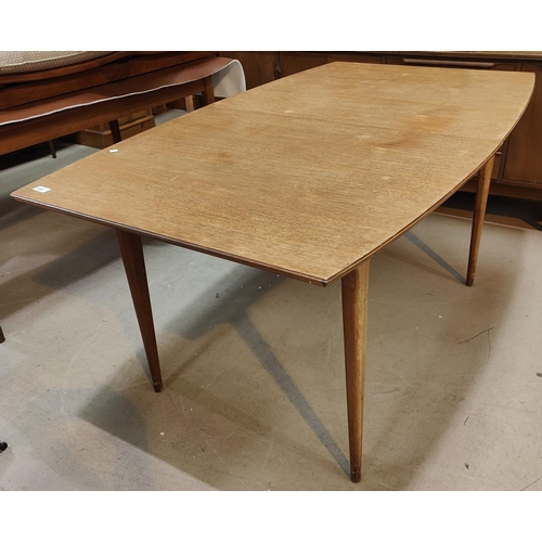 959 - A 1960's shaped rectangular extending teak dining table by Mackintosh