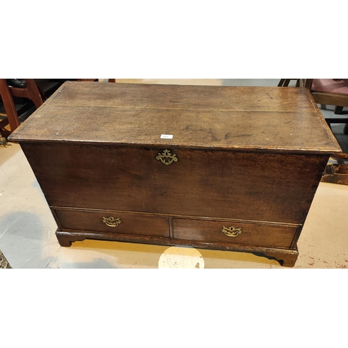 962 - An 18th century oak mule chest with hinged top, 2 drawers and bracket feet, width 104cm