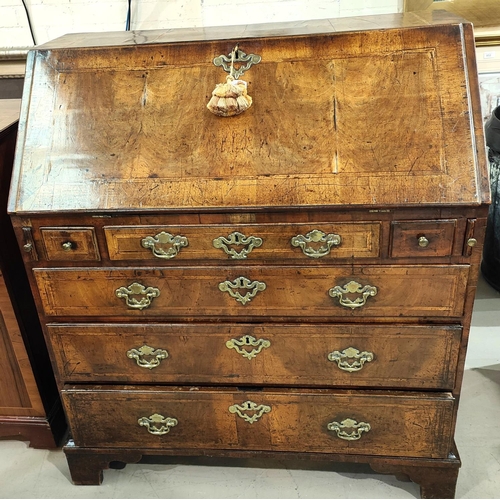 963 - A mid 18th century figured walnut fall front bureau with wide crossbanding and herringbone line inla... 