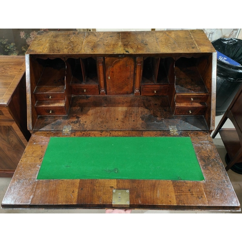 963 - A mid 18th century figured walnut fall front bureau with wide crossbanding and herringbone line inla... 