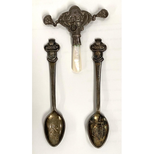 156 - Two white metal Rolex Bucherer teaspoons with Rolex crown finials and a white metal and mother of pe... 