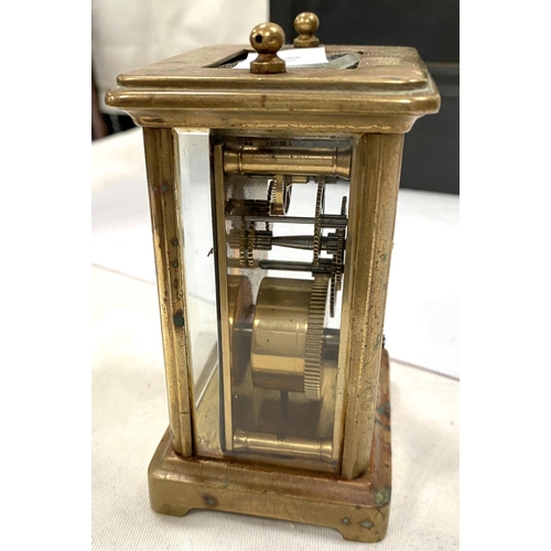 176 - A slate mantel clock with enamel dial, Roman numerals, two brass carriage clocks, a.f