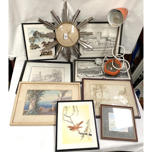 180 - A vintage sunburst wall clock; a vintage lamp and prints.