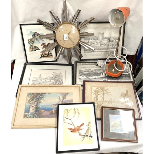 180 - A vintage sunburst wall clock; a vintage lamp and prints.