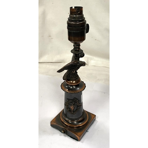 190A - A bronzed table lamp in the form of eagle perched on column with squared base, height 29cm