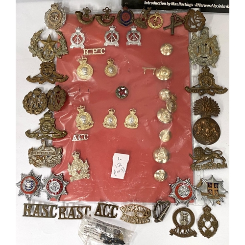 270 - A small collection of military badges on board, a collection of loose military badges and two books ... 