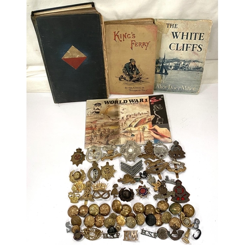 279 - A collection of various military badges etc and military books