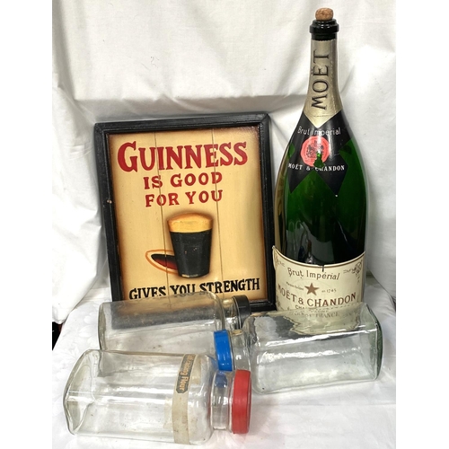 28 - A reproduction Guinness advertising sign, an Empty 900cl Moet & Chandon  display bottle etc