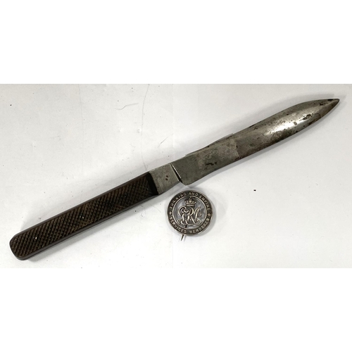 282 - A stainless steel knife with ridged wooden handle A Cox Limited and a WWI wound badge numbered