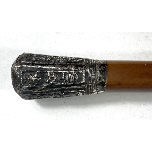 406 - A Chinese military style walking cane with white metal embossed final with plants etc