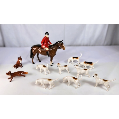 451 - A Beswick Fox Hunting set of huntsmen, 8 hounds and 2 foxes