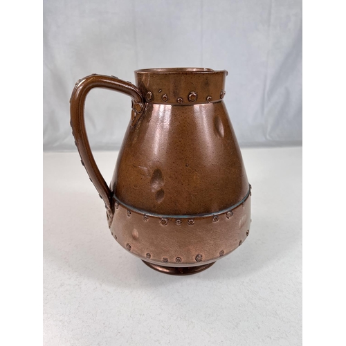 472 - An unusual Arts & Crafts jug by Doulton Silicon in copper coloured finish with rivet decoration,... 