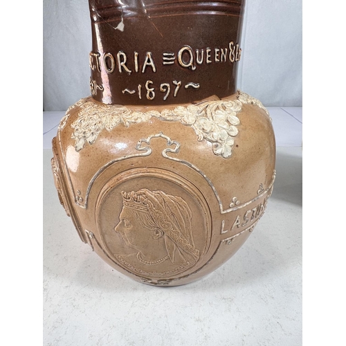 476 - A Doulton brown stoneware jug commemorating Queen Victoria's Diamond Jubilee 1897, ht. 20cm (spout r... 