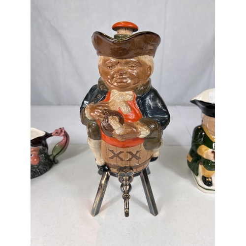 479 - A novelty Doulton stoneware decanter in the form of a man sitting astride a barrel, tap under and ot... 