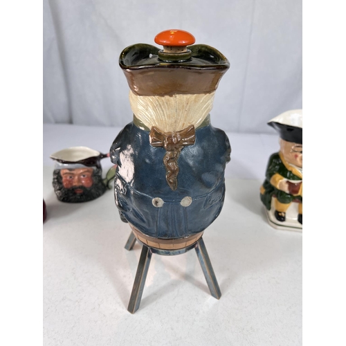 479 - A novelty Doulton stoneware decanter in the form of a man sitting astride a barrel, tap under and ot... 