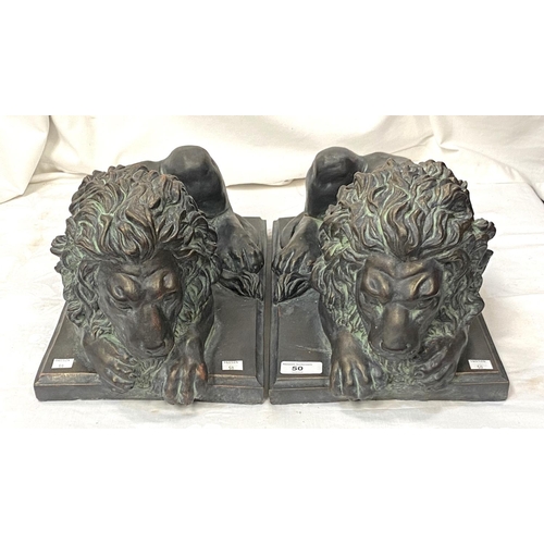 50 - A pair of good sized bronzed composition threshold lions reclining, length 45cm