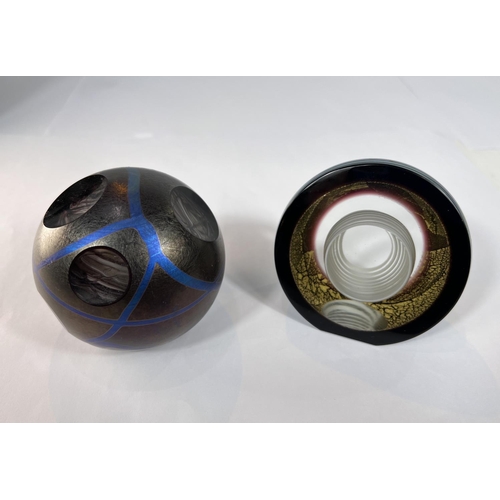 502 - Paperweights: Two Okra glass studios paperweights, one dark lustre with blue lines and sliced areas ... 