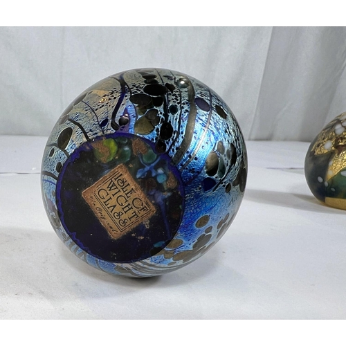 510 - Isle of Wight Glass: three labelled paperweights with gold leaf and varying colours and an iridescen... 