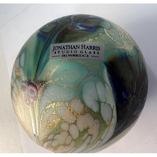 511 - Johnathan Harris Studio Glass: a black and white paperweight with gold leaf highlights, signed and l... 