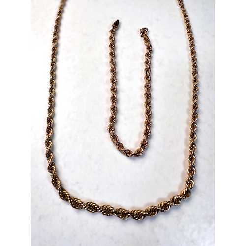 602 - A rope twist neck chain and matching bracelet stamped 585, 23.75gm