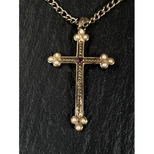 604 - A seed pearl and ruby set yellow metal cross pendant stamped 375 on curb link chain stamped 375, 9gm