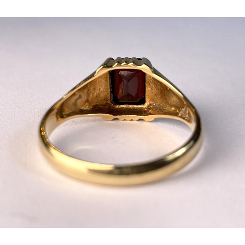 617 - An 18 carat hallmarked gold gent's ring set large cushion cut garnet coloured stone. 6gm, size W/X