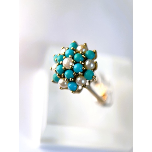 620 - A 9 carat hallmarked gold ring with seed pearls and turquoise in tiered setting, 3.4gm, size N/O