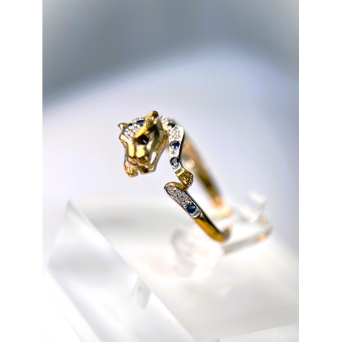 627 - A 9ct hallmarked gold ring in the form of a leopard pouncing set with small sapphires and illusion s... 