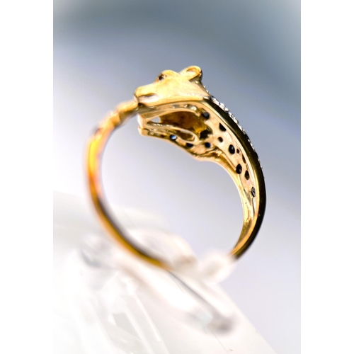 627 - A 9ct hallmarked gold ring in the form of a leopard pouncing set with small sapphires and illusion s... 