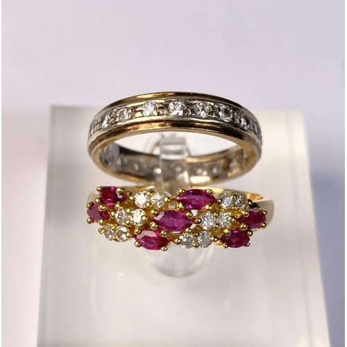 631 - A yellow metal dress ring set with diagonal bands of rubies and diamonds (markes rubbed) 3.9gm, size... 