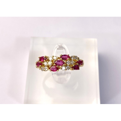 631 - A yellow metal dress ring set with diagonal bands of rubies and diamonds (markes rubbed) 3.9gm, size... 