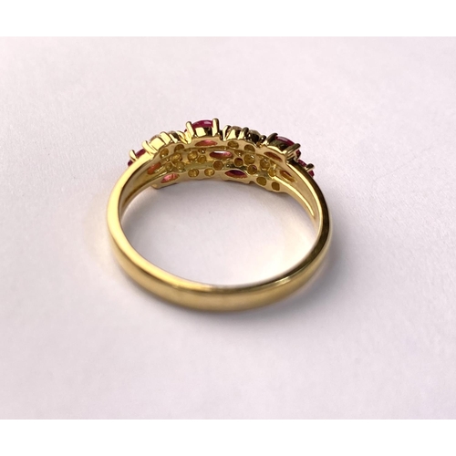 631 - A yellow metal dress ring set with diagonal bands of rubies and diamonds (markes rubbed) 3.9gm, size... 