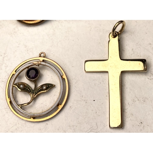 634 - A 9 carat hallmarked gold cross; an open circular pendant with enamel inner circle and inset flower ... 