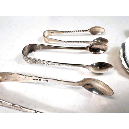 641 - A mixed selection of hallmarked silver teaspoons, sugar tongs etc, 5.3oz