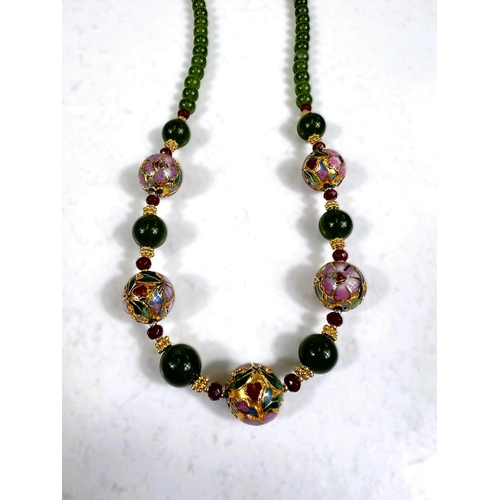 651 - A string of jade green and cloisonne gilt metal beads with faceted garnet spacers, marked JK.NYC, a ... 