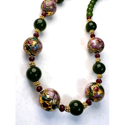 651 - A string of jade green and cloisonne gilt metal beads with faceted garnet spacers, marked JK.NYC, a ... 