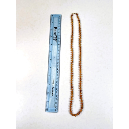 653 - A string of 19th century yellow amber beads with gilt metal spacers , 64cm, 18gm approx