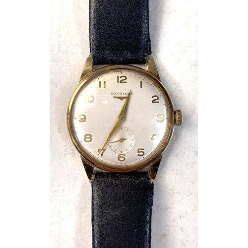 666 - A Longines gents gold watch with champagne dial and Roman numerals on black leather strap (inscribed... 