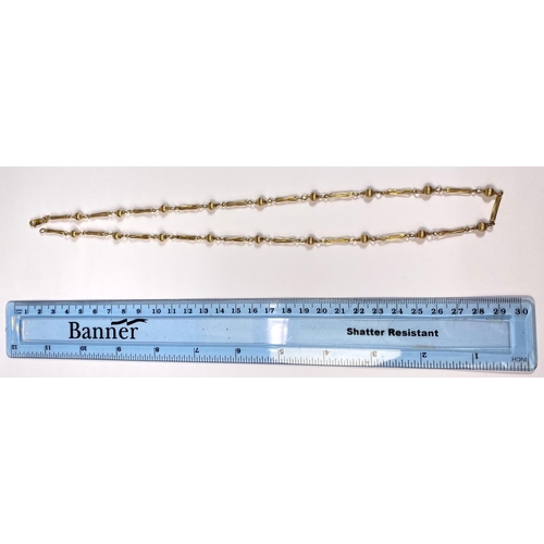 671 - A yellow metal chain stamped 9K formed from alternating reeded ball and elongated twisted links, 13.... 