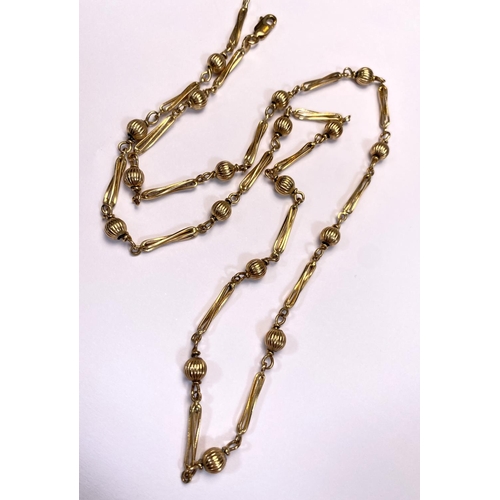 671 - A yellow metal chain stamped 9K formed from alternating reeded ball and elongated twisted links, 13.... 