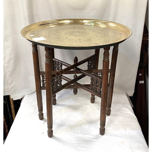 68 - A 19th / 20th century Eastern brass table with folding wood legs