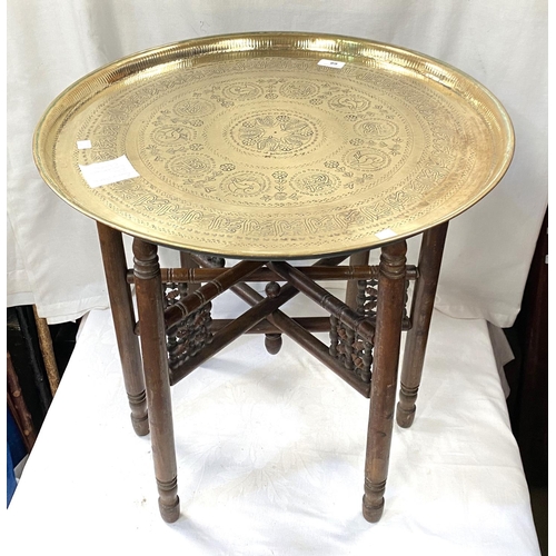 68 - A 19th / 20th century Eastern brass table with folding wood legs