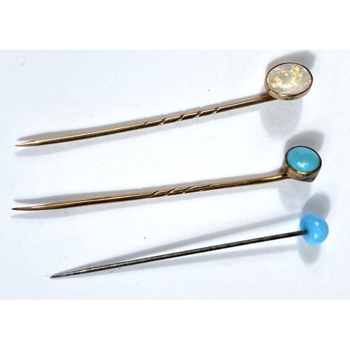 689 - A cased opal and 9ct gold stick pin and two others set with Turquoise stones cased