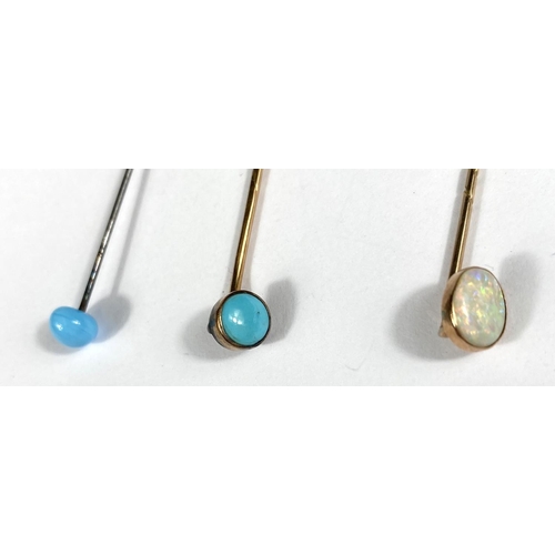 689 - A cased opal and 9ct gold stick pin and two others set with Turquoise stones cased