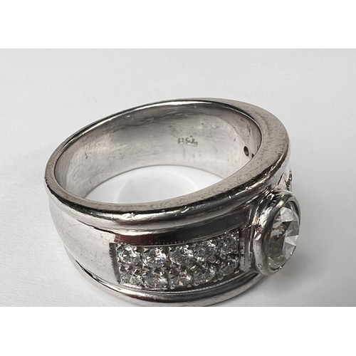 696 - A gent's heavy dress ring with wide white metal shank set with central oval diamond approx. 1.06 car... 