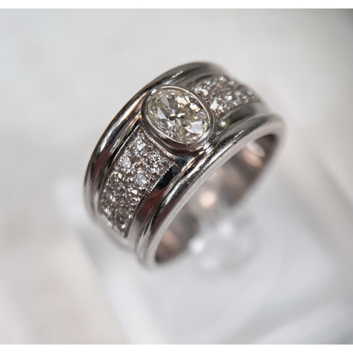 696 - A gent's heavy dress ring with wide white metal shank set with central oval diamond approx. 1.06 car... 