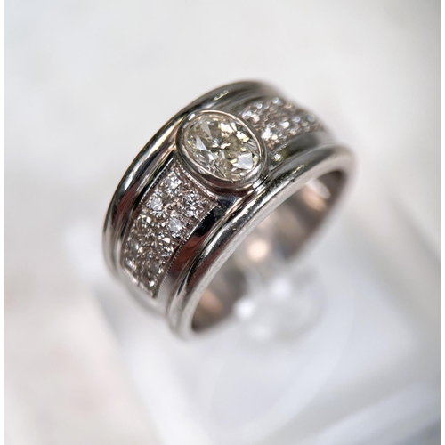 696 - A gent's heavy dress ring with wide white metal shank set with central oval diamond approx. 1.06 car... 