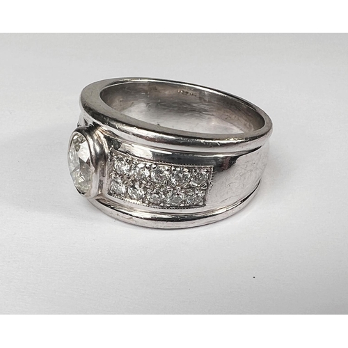 696 - A gent's heavy dress ring with wide white metal shank set with central oval diamond approx. 1.06 car... 