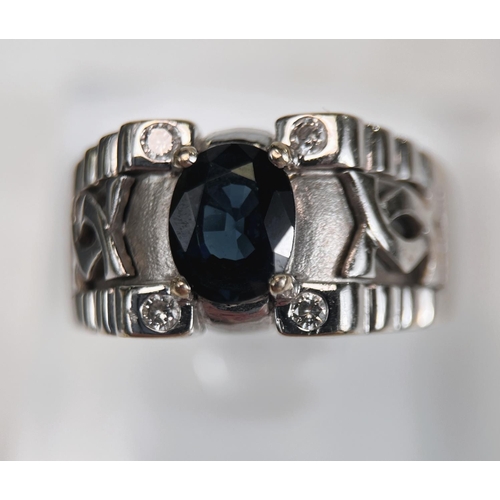 710 - A gent's dress ring with wide white metal shank set with central oval sapphire with small diamond to... 